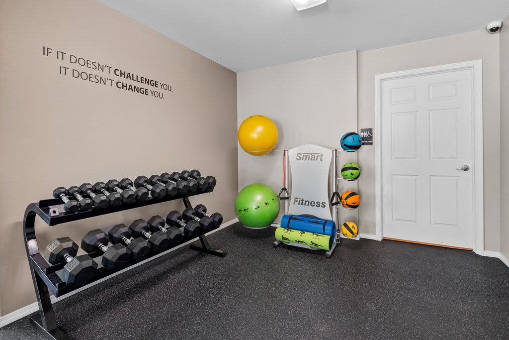 24-hour fitness center at cardio machines and weights at Woodland Villa Apartments in Westland, MI.