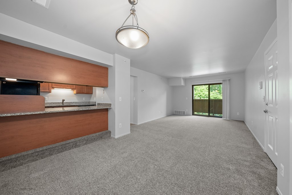 Cozy living room with natural light at Woodland Villa Apartments in Westland, MI.