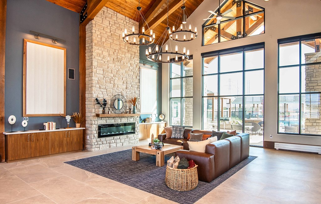 a living room with a fireplace and large windows