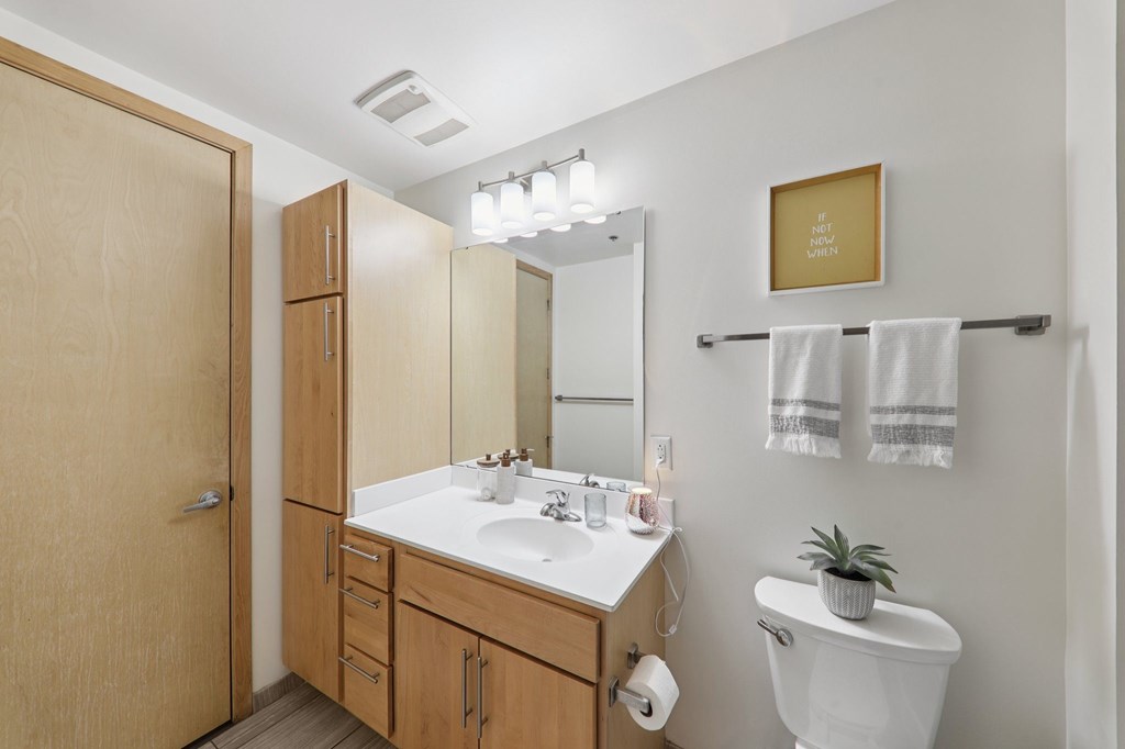 A bathroom with a white sink and a toilet.