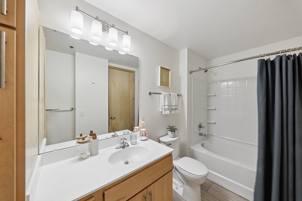 A bathroom with a white sink and a white toilet.