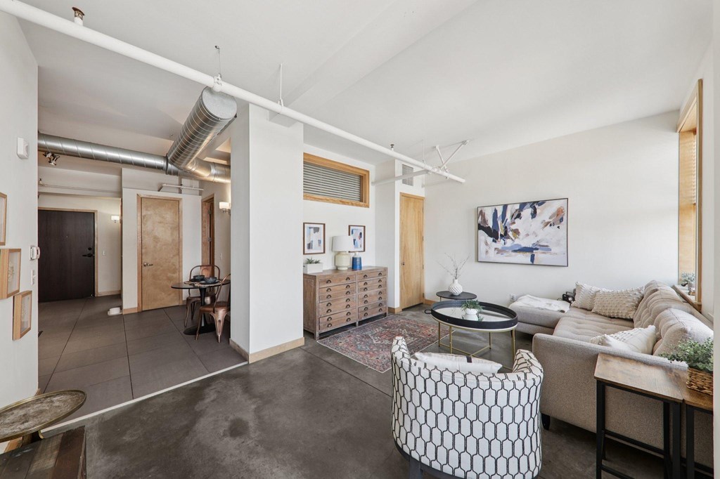 A living room with a couch, a chair, and a coffee table.