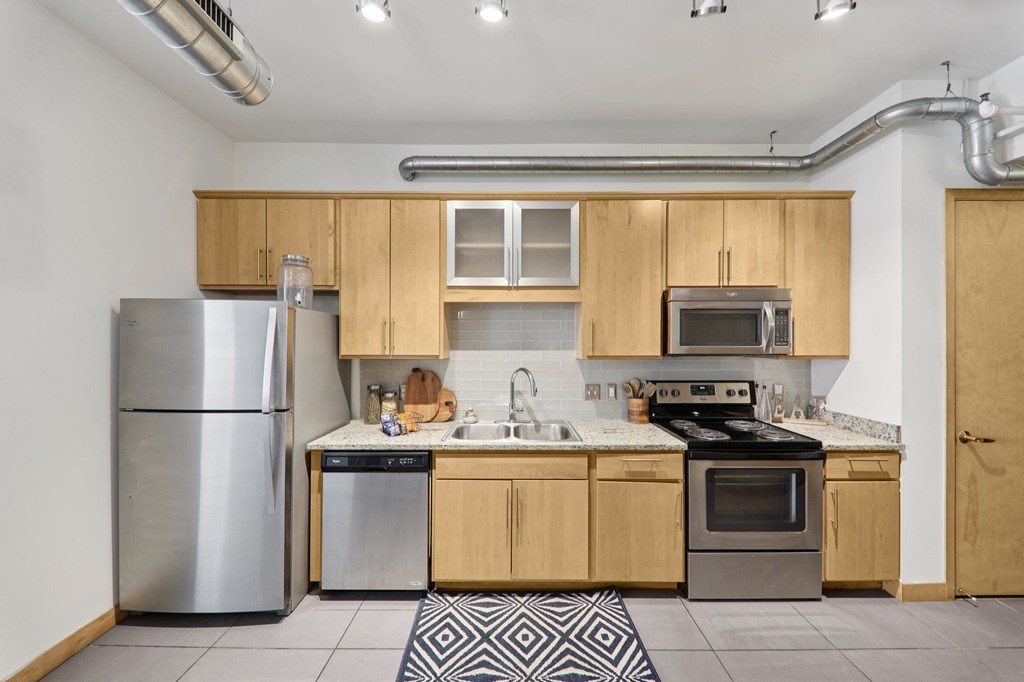A kitchen with wooden cabinets and stainless steel appliances.