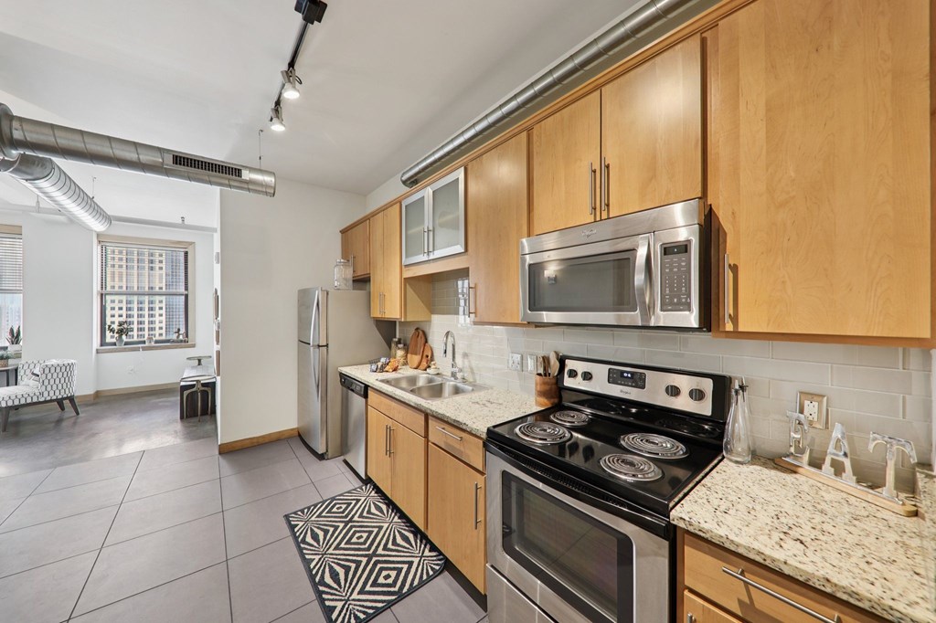 A kitchen with a stove top oven and microwave above it.