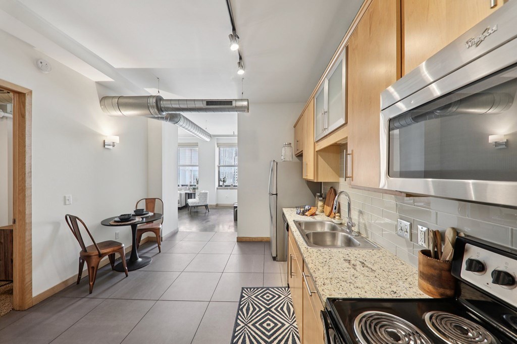 A kitchen with a stove top oven and a microwave.