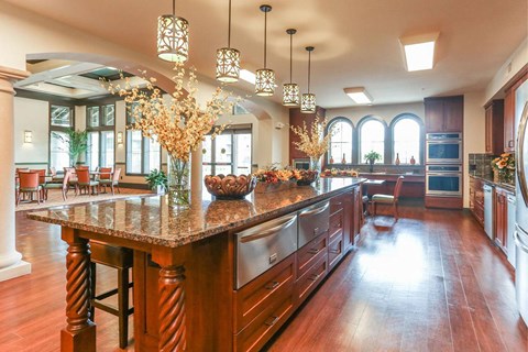 a large kitchen with a large island with granite counter tops