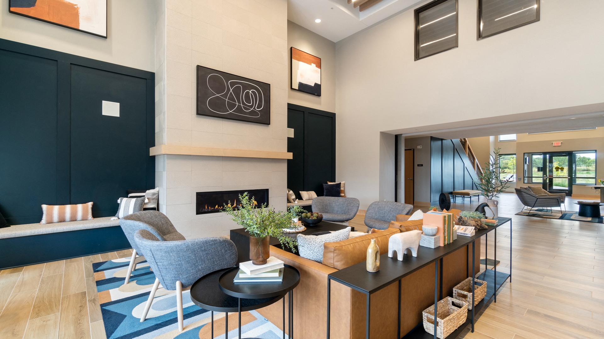 a living room with a fireplace and a table with chairs