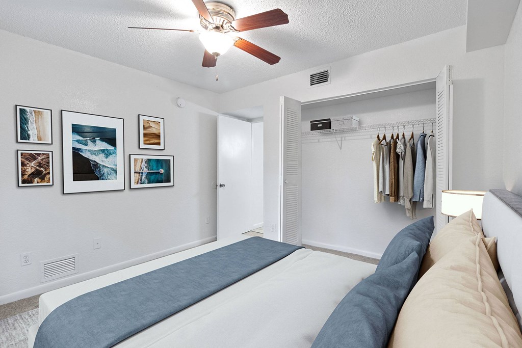 a bedroom with a bed and a ceiling fan