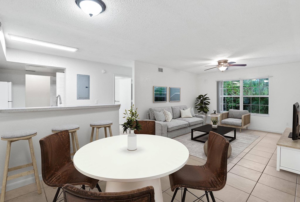 a living room with a white table and chairs