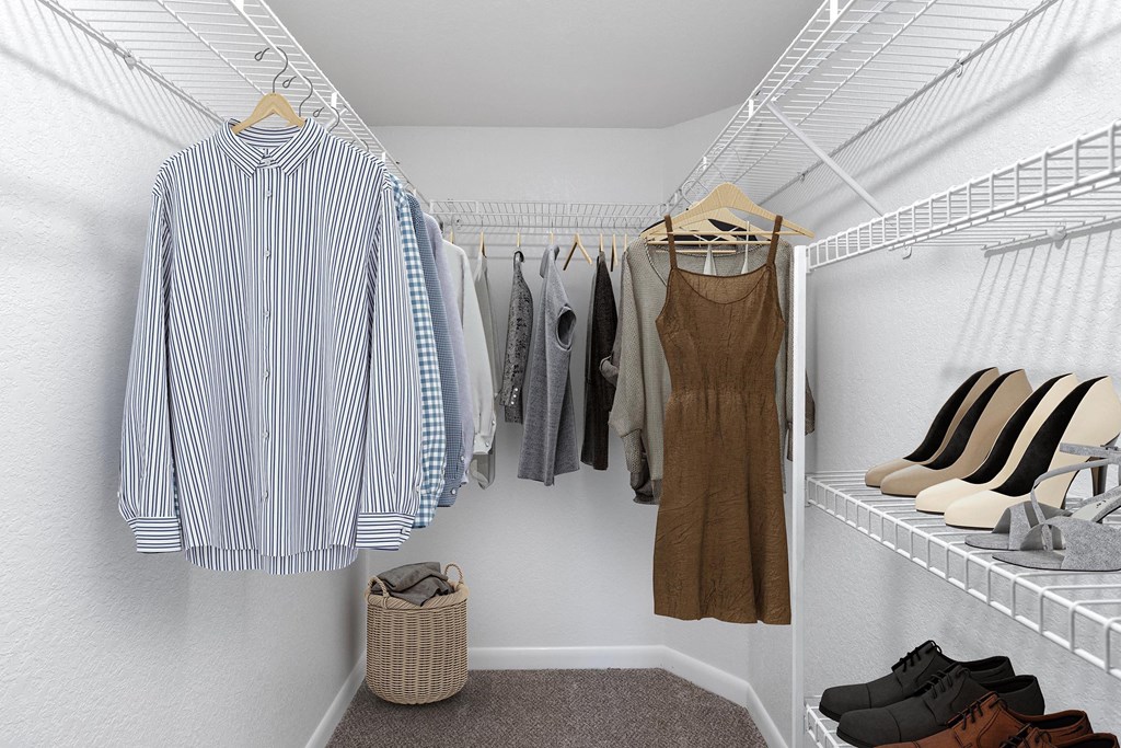 a walk in closet filled with clothes and shoes