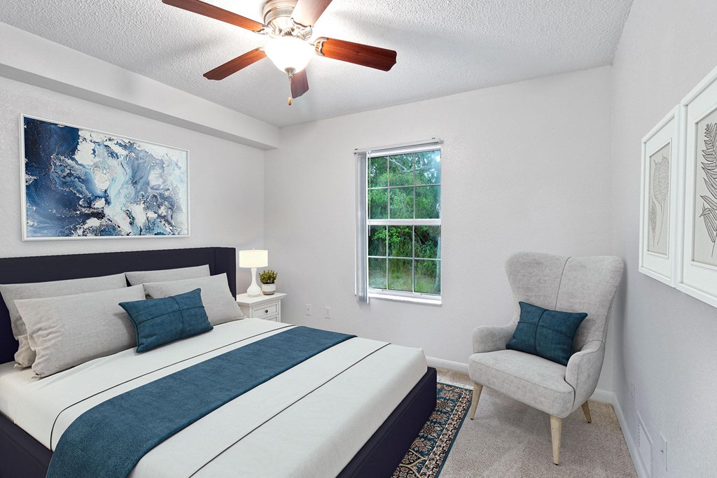 a bedroom with a bed and a ceiling fan