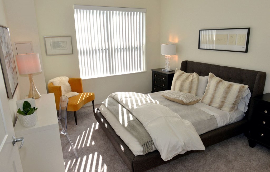 Cozy bed and window at 1500 Nicollet Apartment Homes, Minnesota