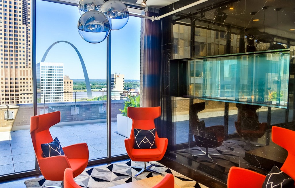 Clubroom with large window at Arcade Apartments, Missouri