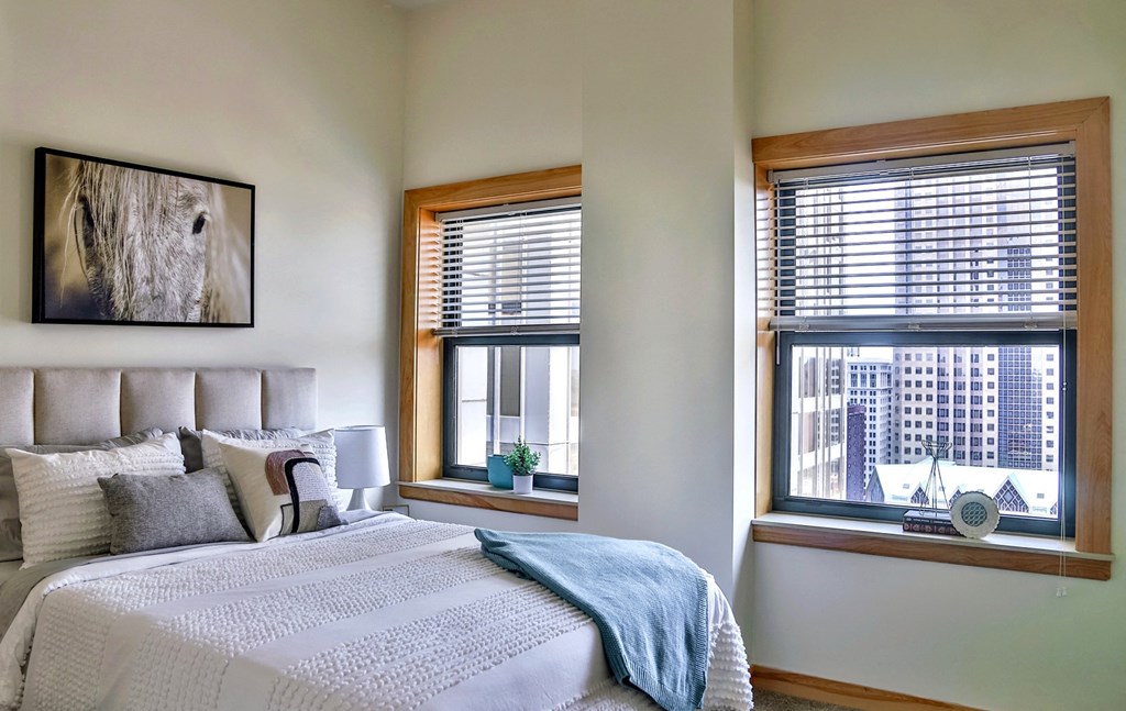 Bedroom with large windows at Arcade Apartments, St Louis, MO