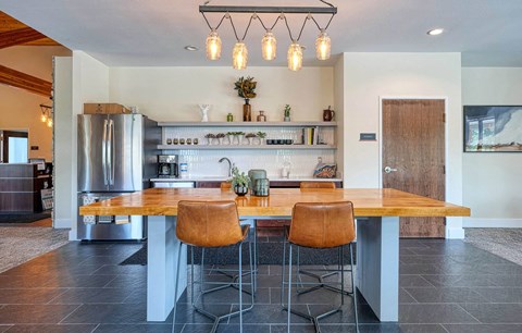 a kitchen with a table and chairs and a refrigerator