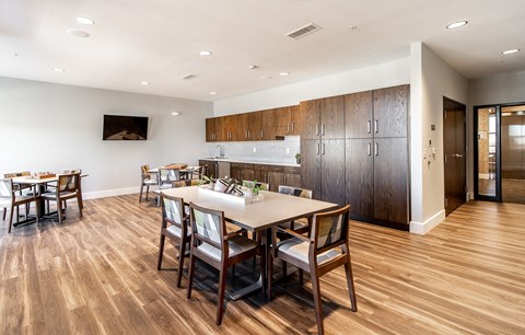 a dining room and kitchen with a table and chairs
