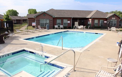A swimming pool with a blue tiled edge and a white ladder.