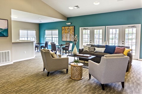 a living room with couches and chairs and a bar
