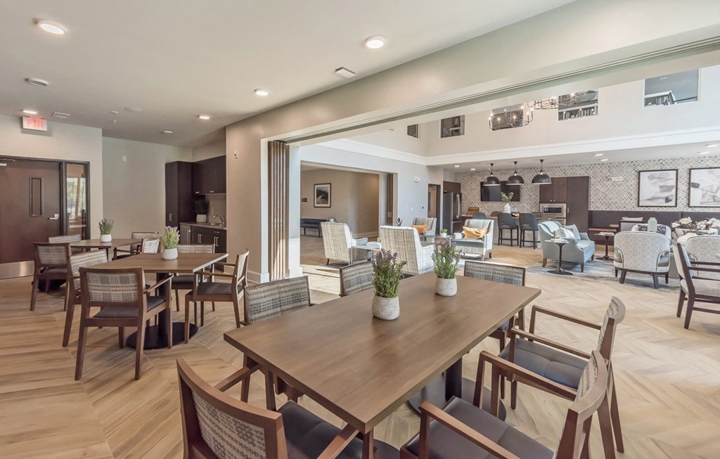 Community Room with chairs and tables at Covington Crossings 55+ Senior Living, Covington, GA, 30014