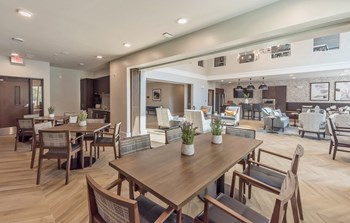 Community Room with chairs and tables at Covington Crossings 55+ Senior Living, Covington, GA, 30014 - Photo Gallery 11