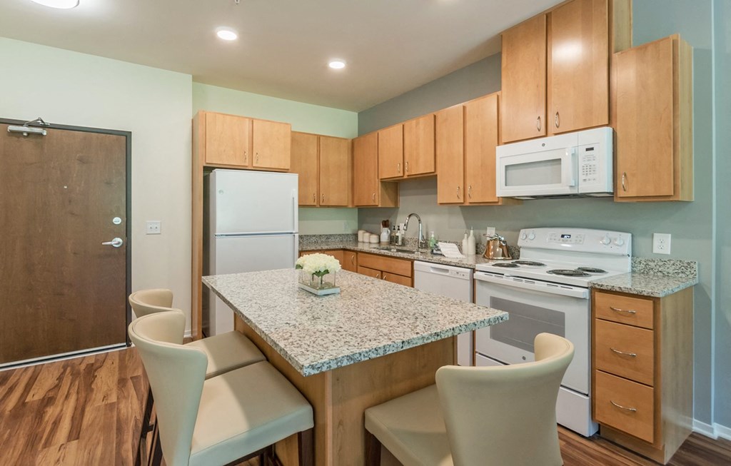 Kitchen with island at Covington Crossings 55+ Senior Living, Covington