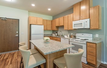 Kitchen with island at Covington Crossings 55+ Senior Living, Covington - Photo Gallery 36