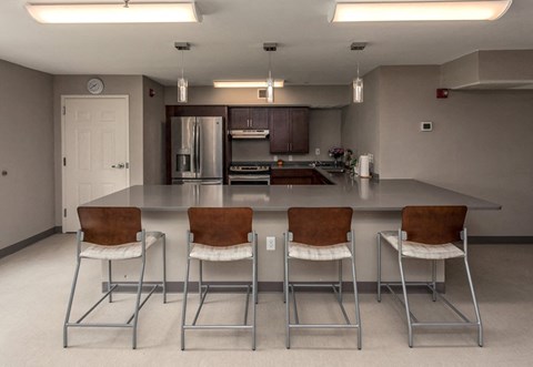 a kitchen with a counter top and chairs
