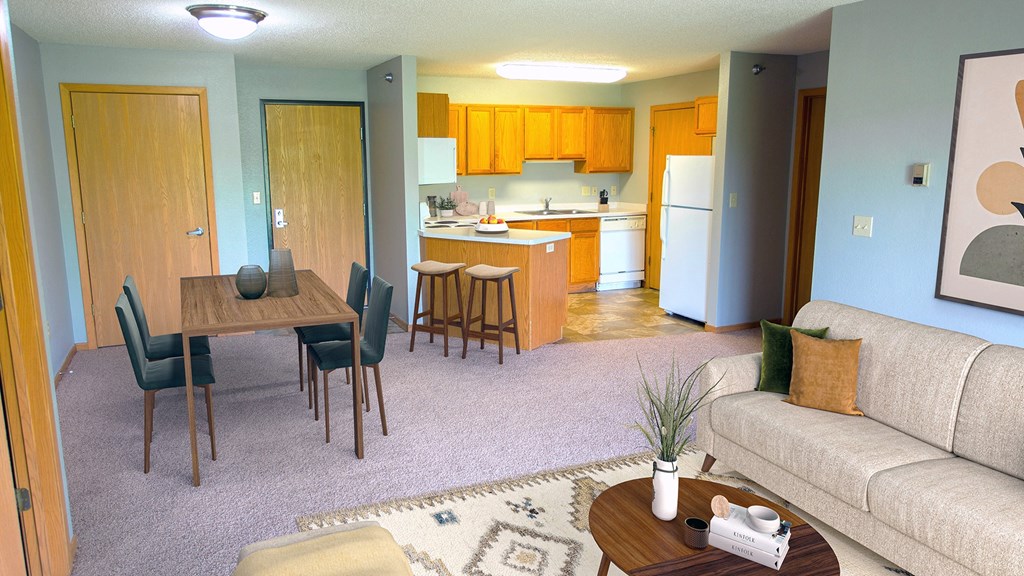 a living room and kitchen with a couch and a table at The Villages at Essex Park, Rochester Minnesota