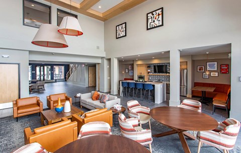 a living room and dining room with a table and chairs