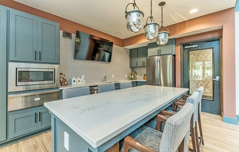 a kitchen with blue cabinets and a white counter top