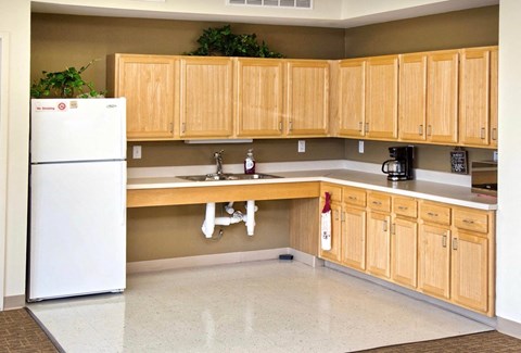 a kitchen with wooden cabinets and a white refrigerator