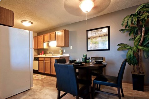 a kitchen and dining room with a table and a refrigerator