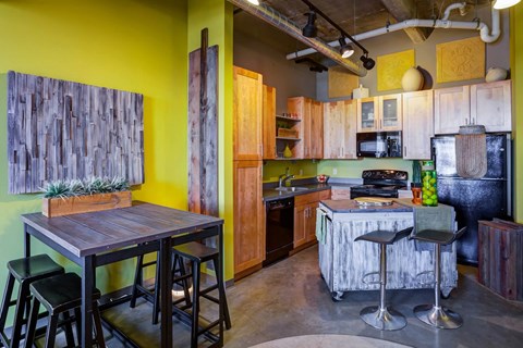 a kitchen and dining room with a bar and a table