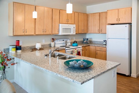 a kitchen with a granite counter top and a sink