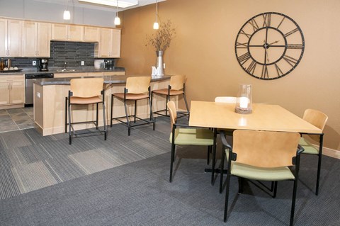 a dining room with a table and chairs and a kitchen