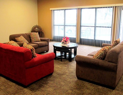 a living room with couches and chairs and a table