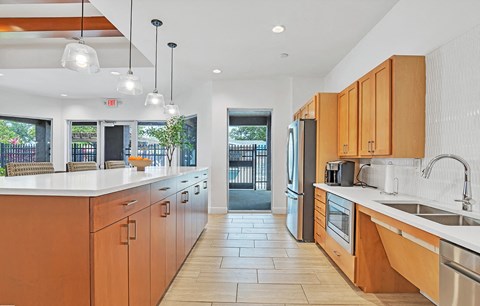 a large kitchen with wooden cabinets and a sink