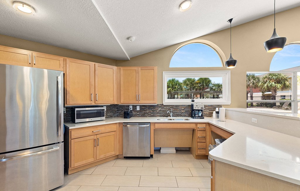 a kitchen with wooden cabinets and stainless steel appliances