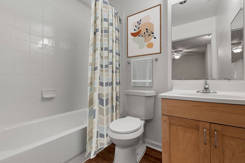 a bathroom with a toilet and a shower curtain
