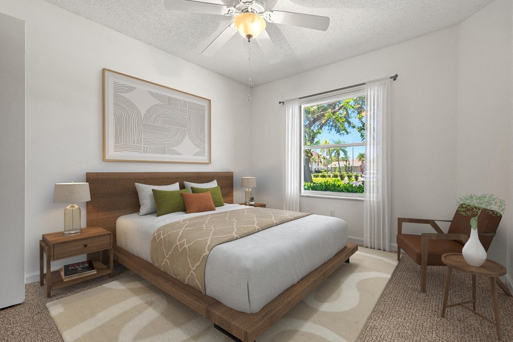 a bedroom with a large bed and a ceiling fan