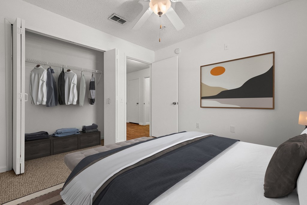 a bedroom with a large bed and a closet