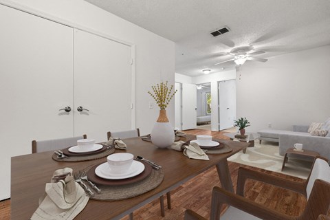 a dining room with a table and chairs and a ceiling fan