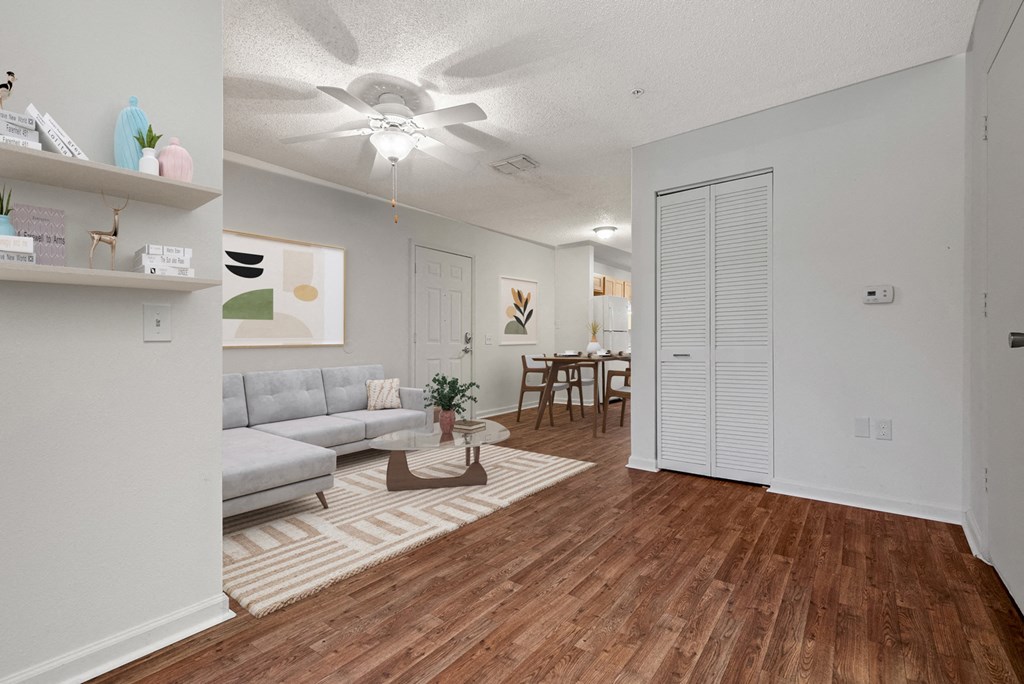 an open living room and dining room with a ceiling fan