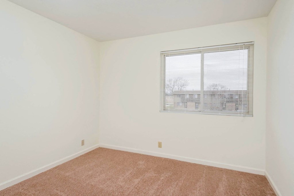 Bedroom with window at RiverEast, Iowa