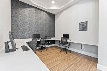 a office with desks and chairs and a chalkboard on the wall at Sandy Creek Apartments, Bryan, Texas