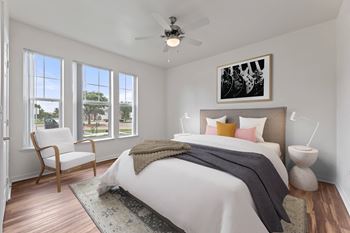 a bedroom with a large bed and a ceiling fan at Sandy Creek Apartments, Texas