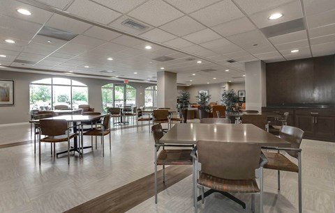 a large dining room with tables and chairs
