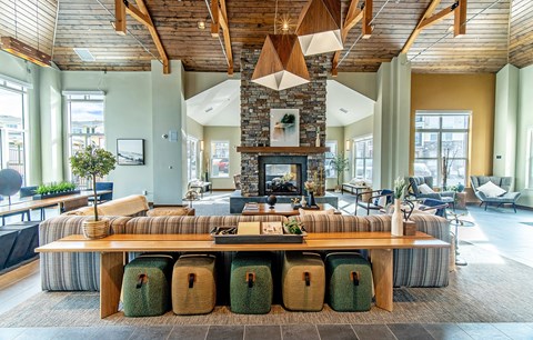 a large living room with a fireplace and a large table