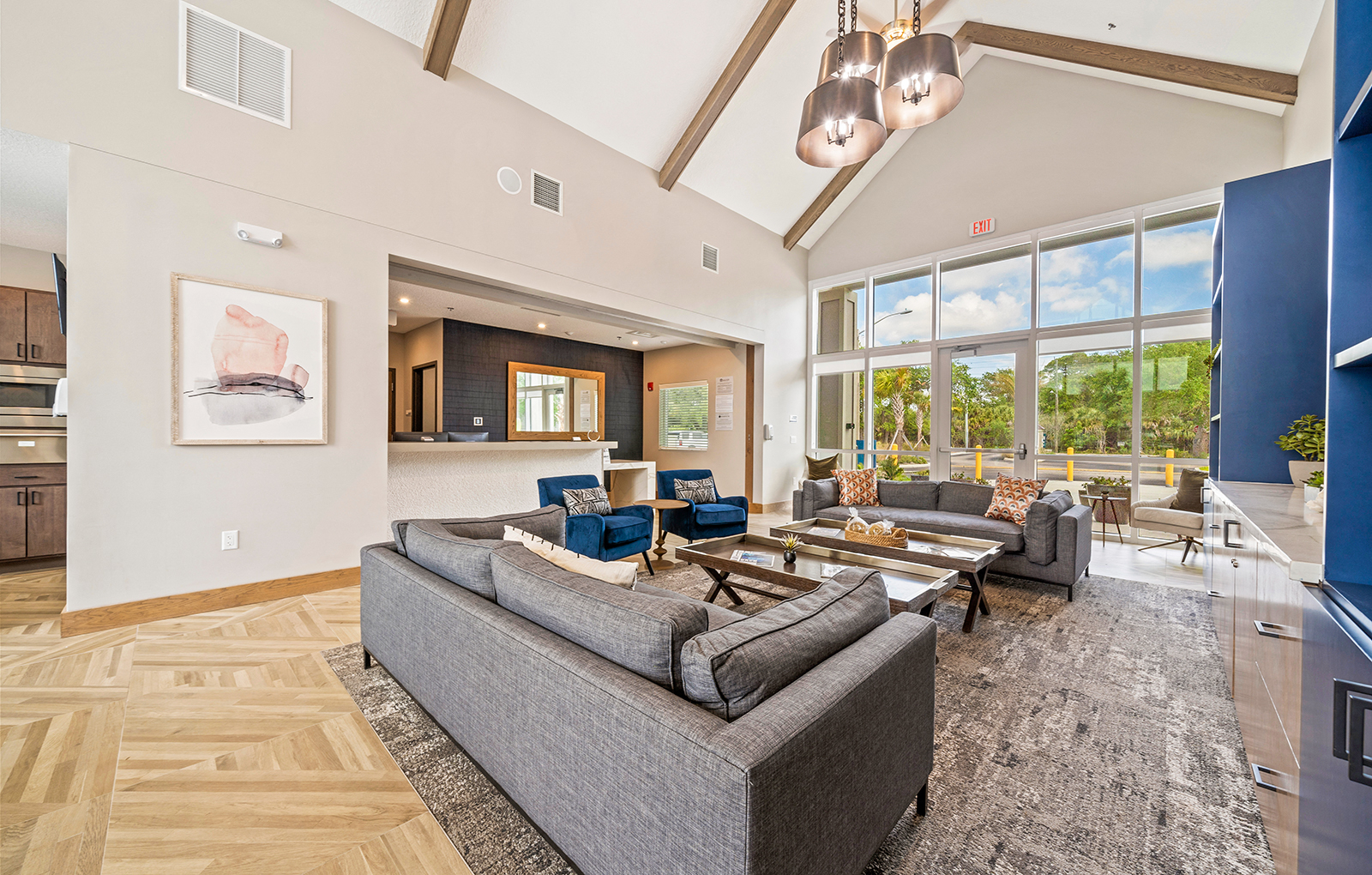 a living room with couches and chairs and a large window