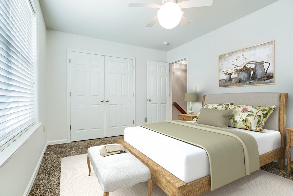 a bedroom with a bed and a ceiling fan